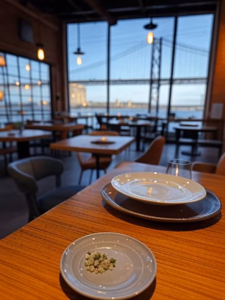 Stylish riverside restaurant in industrial converted space, modern eclectic decor, 25 de Abril bridg