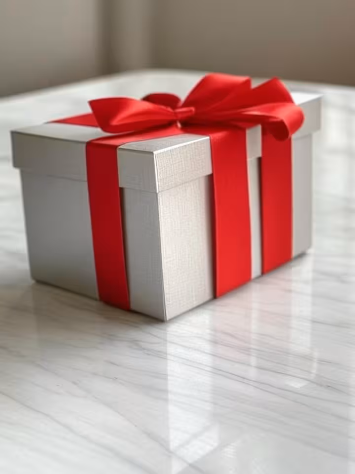 Elegant gift box with luxury ribbon on marble table, soft natural lighting, sophisticated compositio